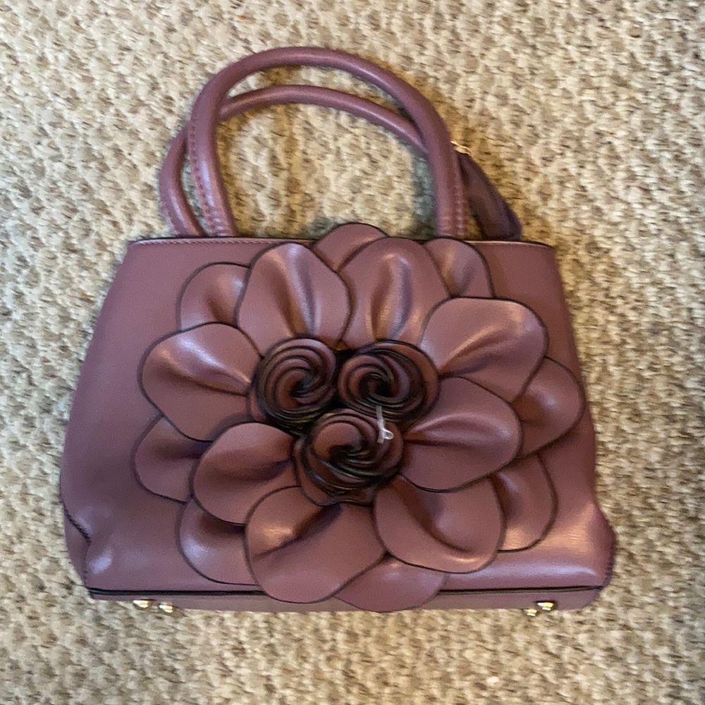 Lavender handbag with large flower detail.